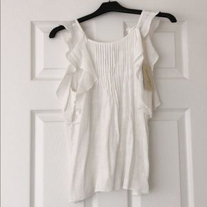 White ruffle sleeveless top.